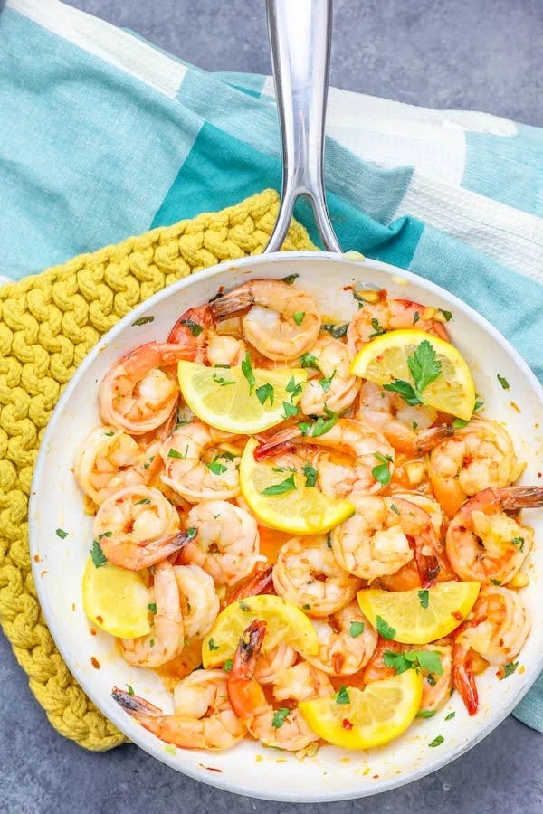 Easy garlic butter shrimp skillet with lemon wedges.