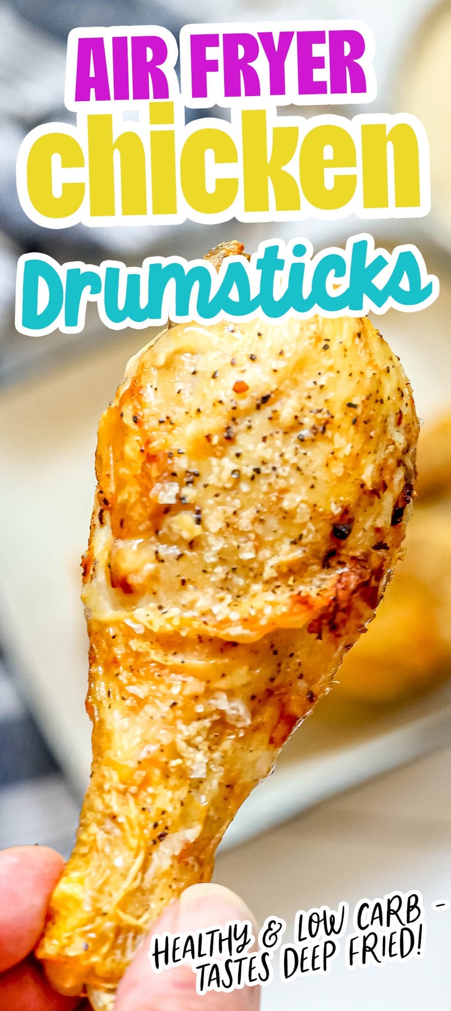 picture of a hand holding an air fried chicken drumstick