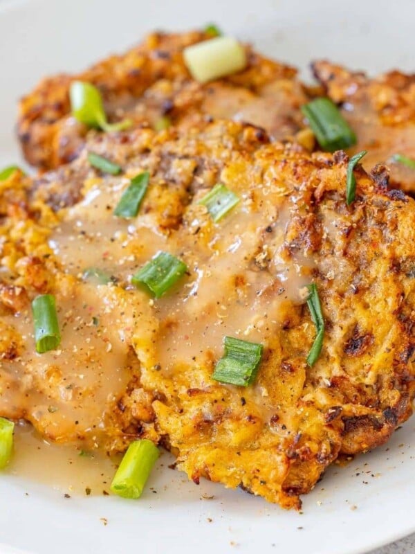 picture of air fried chicken fried steak on a plate topped with gravy and green onions