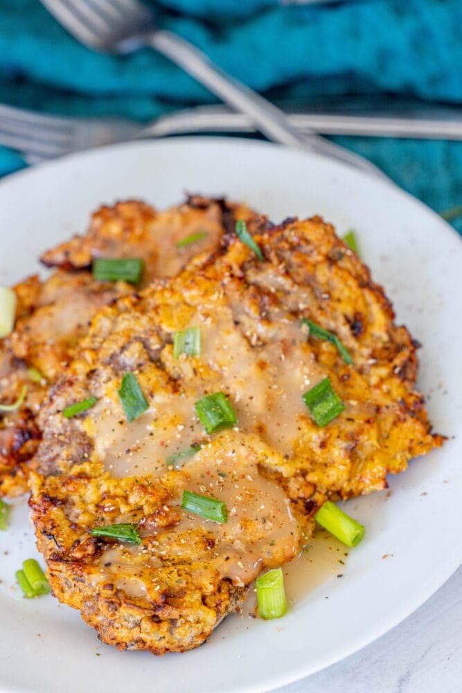 A plate with air fried chicken fried steaks.