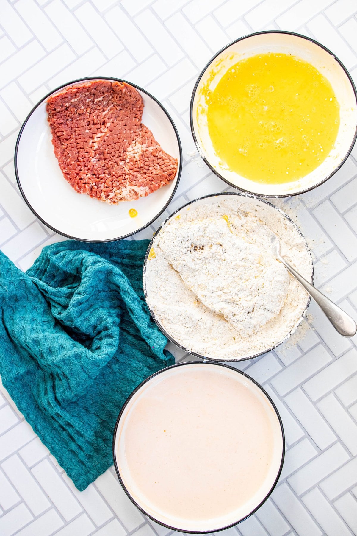 picture of cube steak being dipped in flour