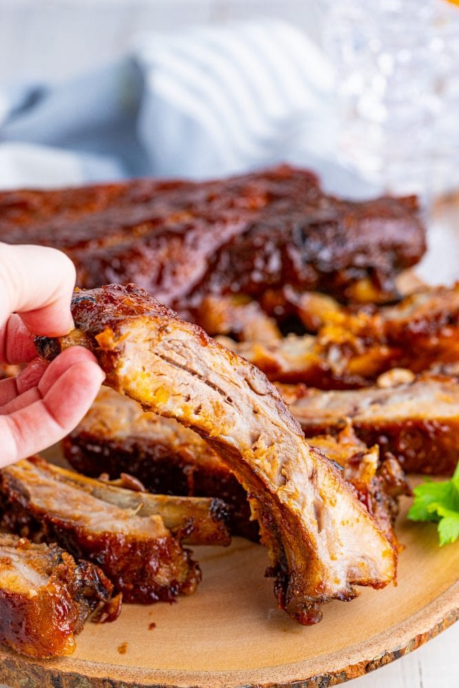 Oven Baked Ribs recipe served on a wooden plate.