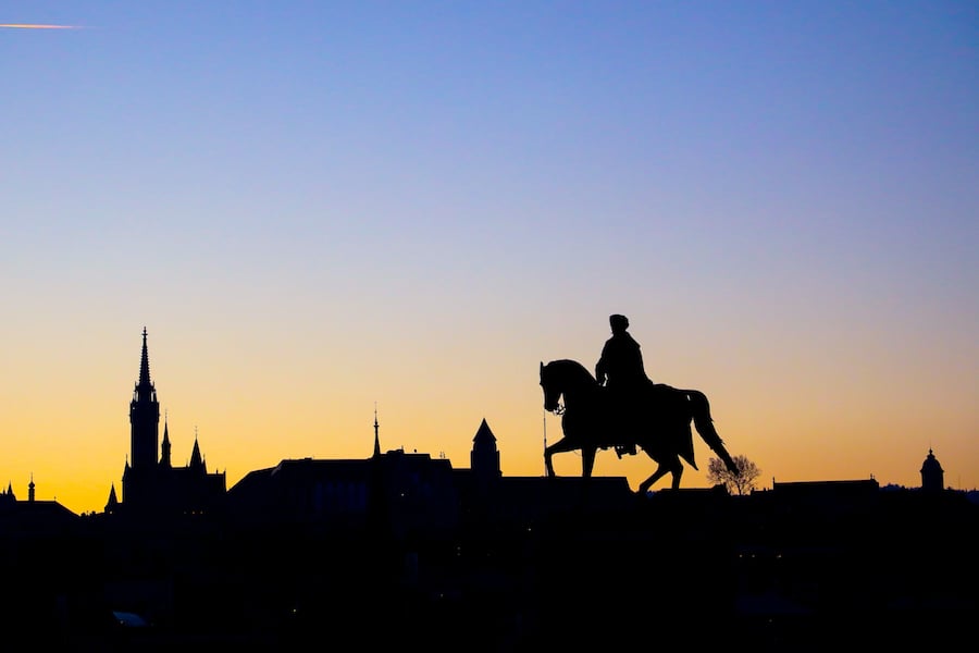 Silhouette of a man riding a horse during a traditional Hungarian Goulash contest.