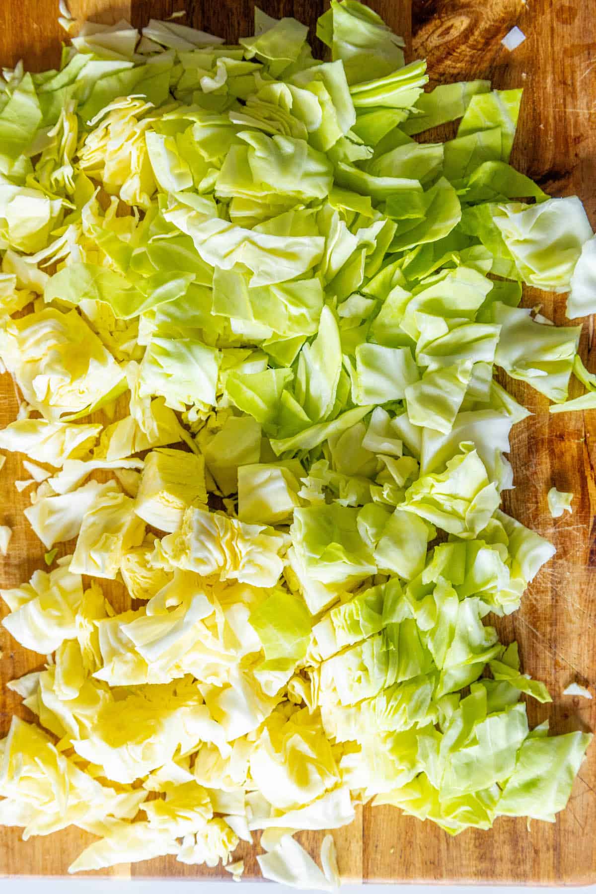 Shredded cabbage on a cutting board, perfect for a Saint Patrick's Day cabbage recipe.
