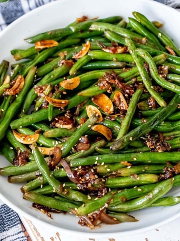 picture of chinese garlic green beans in a white bowl on a table
