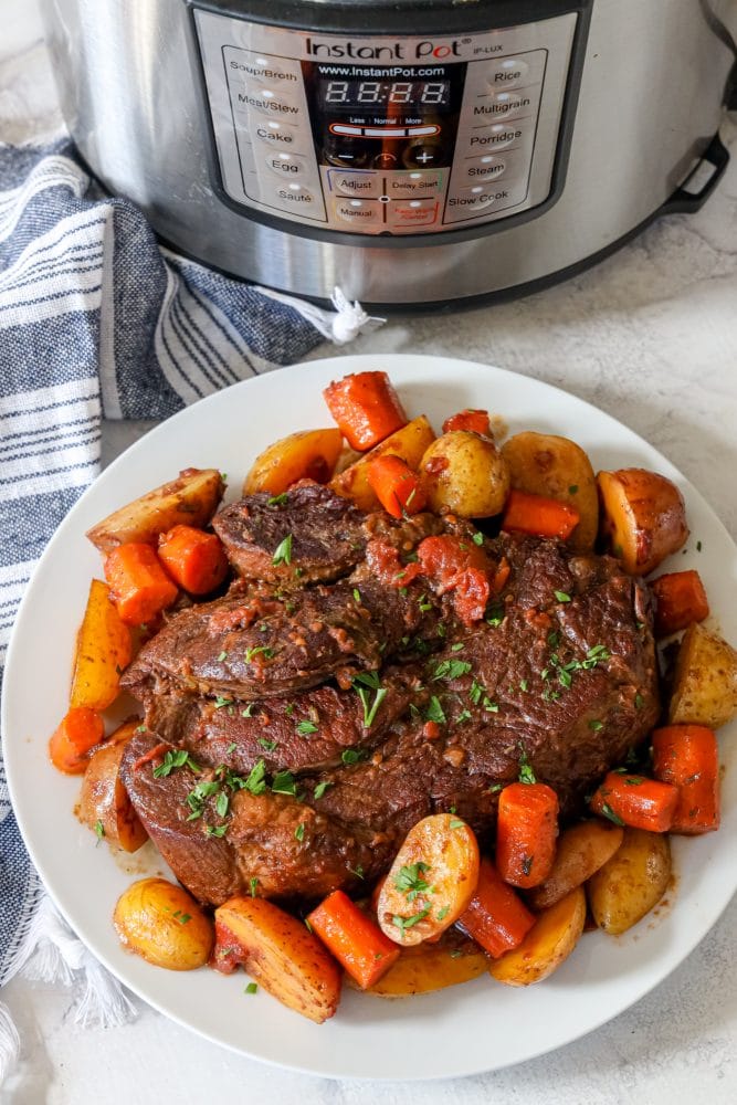 A plate of beef and carrots cooked in an Instant Pot.