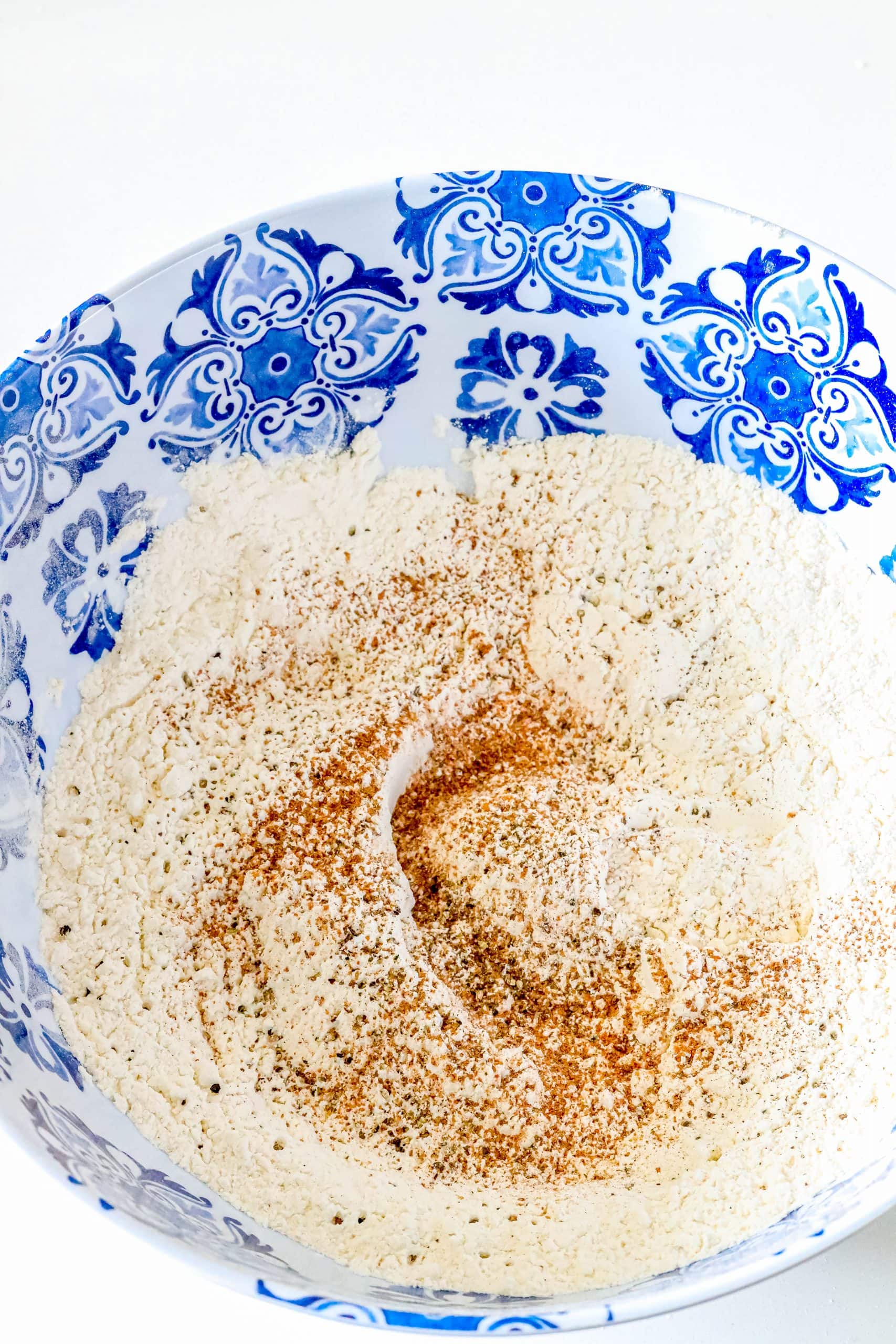 A blue and white bowl with German spaetzle dumplings recipe.