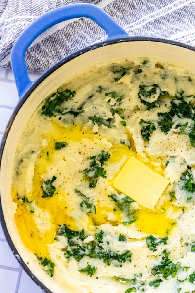 Easy Irish Colcannon Recipe with spinach, butter, and blue pot.