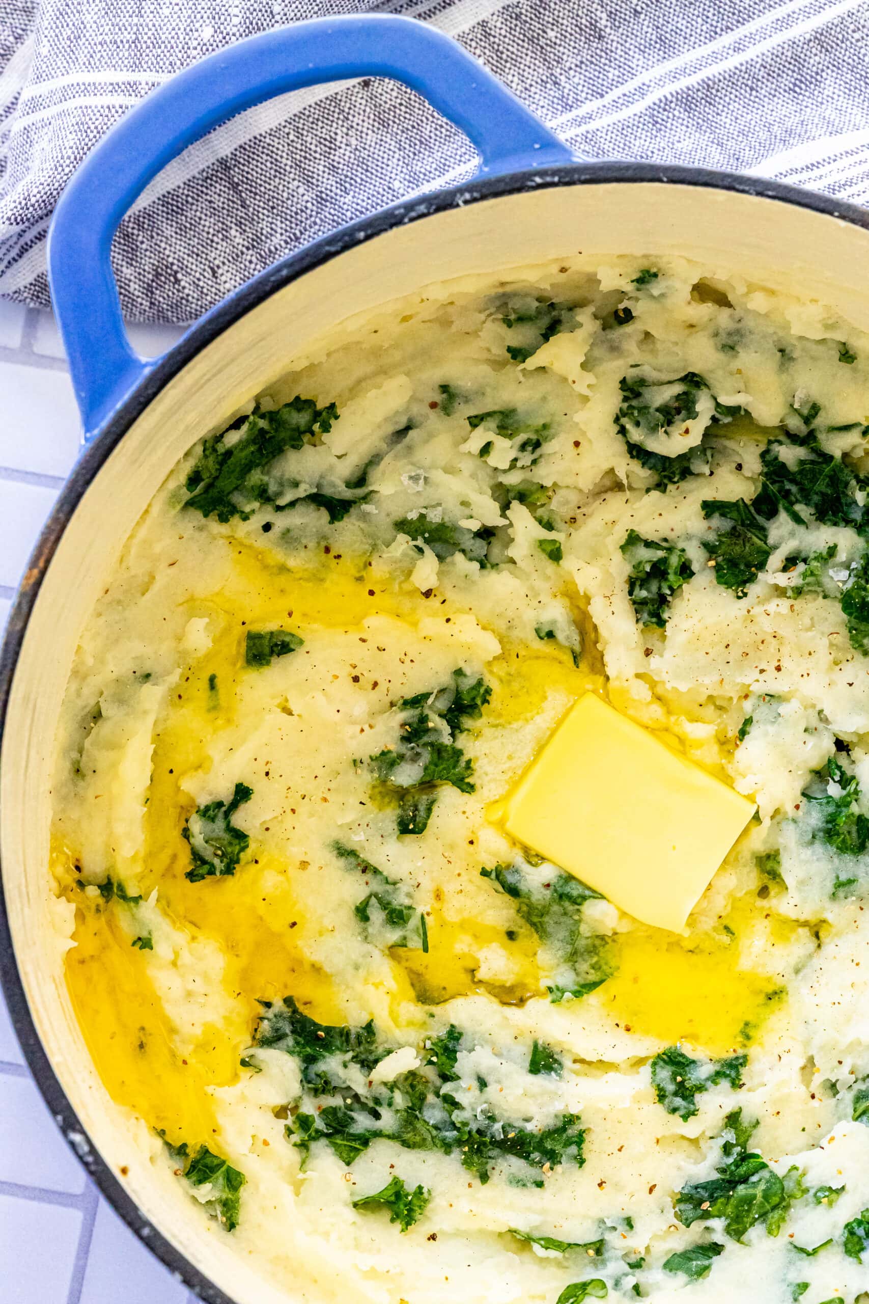 Easy Irish Colcannon Recipe with spinach, butter, and blue pot.