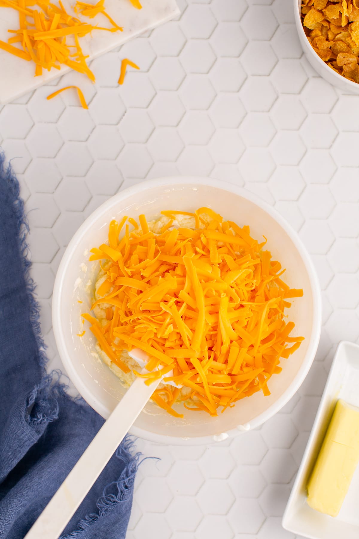 cheese being mixed into soup and butter mixture