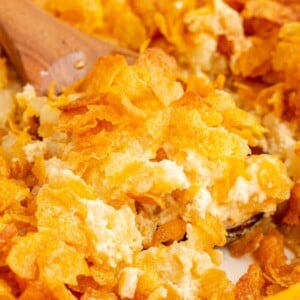 cheesy baked potatoes in a dish topped with cornflakes