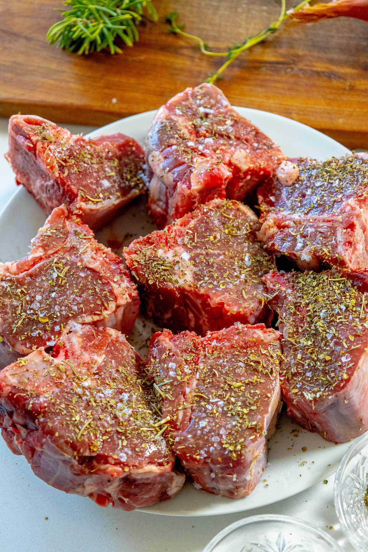 seasoned raw lamb chops on a plate