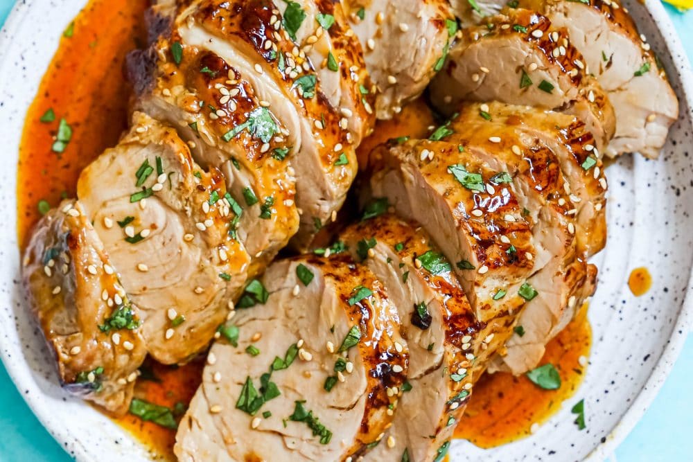 The Best Baked Teriyaki Pork Tenderloin Recipe served with sauce.