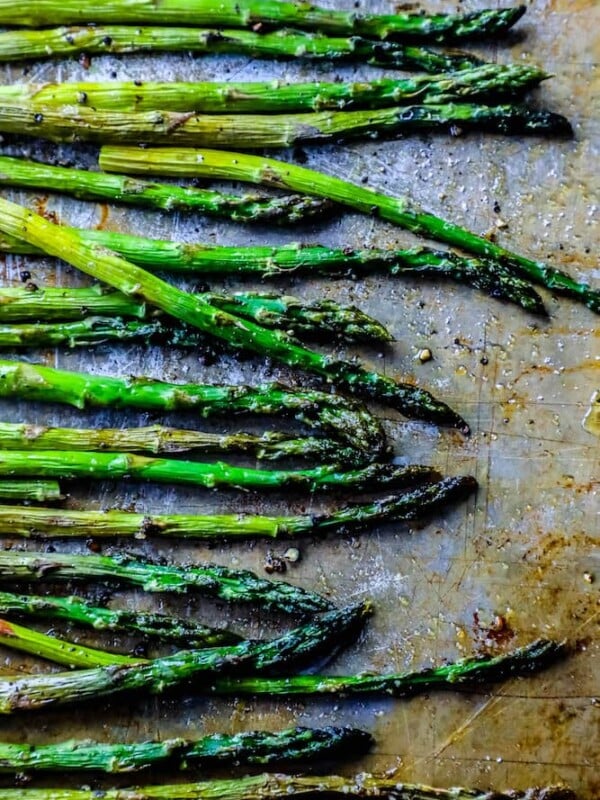 Roasted asparagus on a baking sheet.