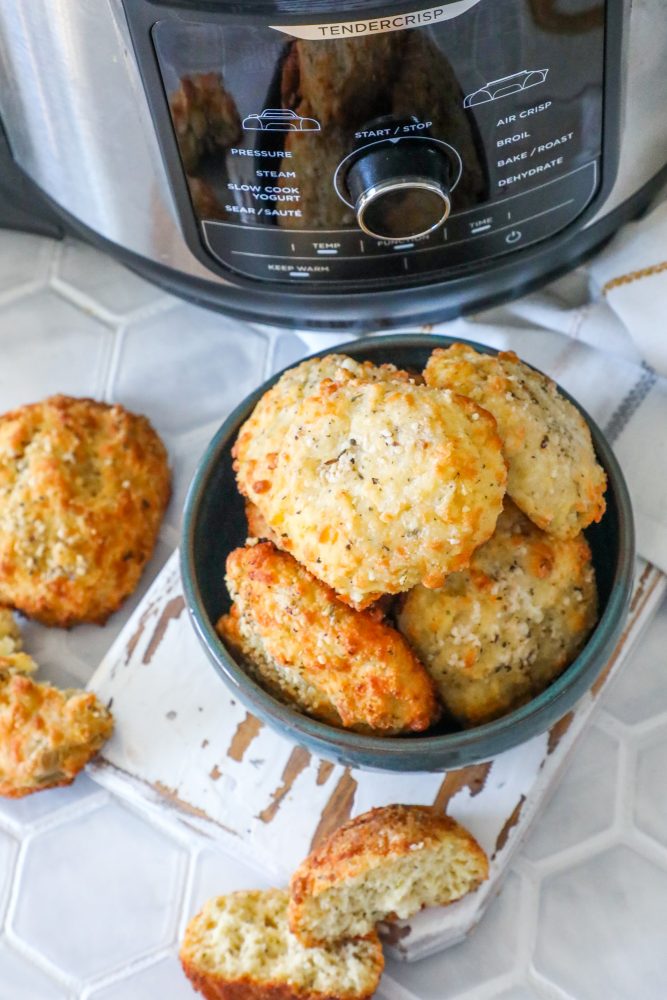 Keto air fryer rolls with cheesy biscuits in front of an instant pot.