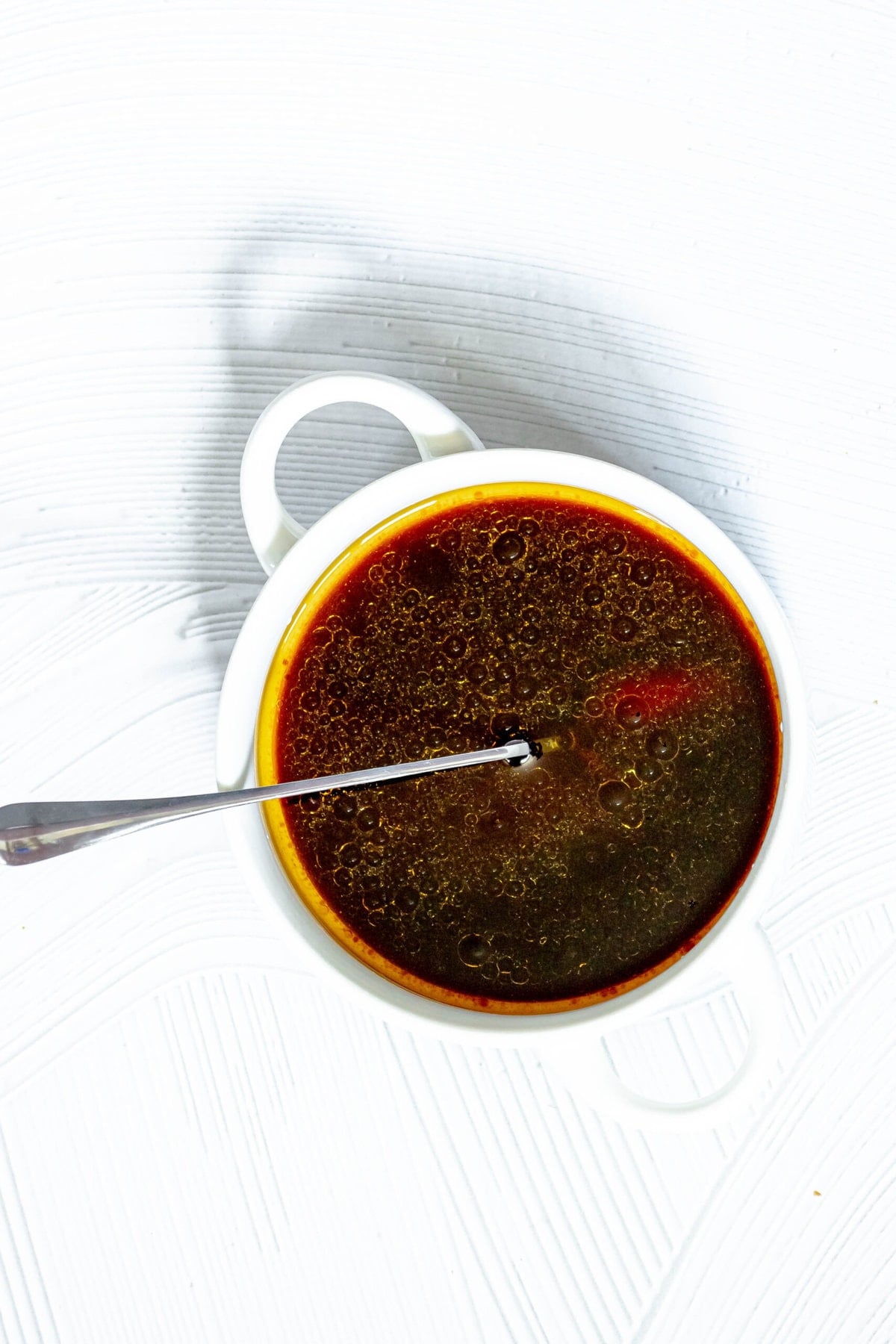 picture of korean bbq sauce in a white bowl with a spoon