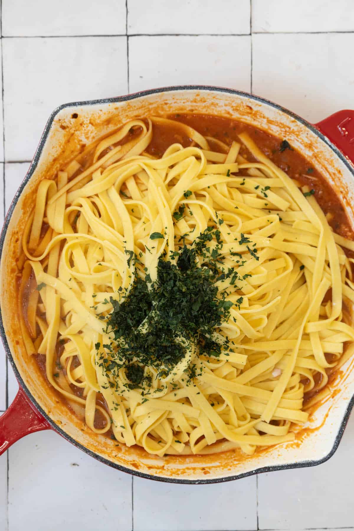 A red skillet filled with Venetian Lobster Busara pasta.