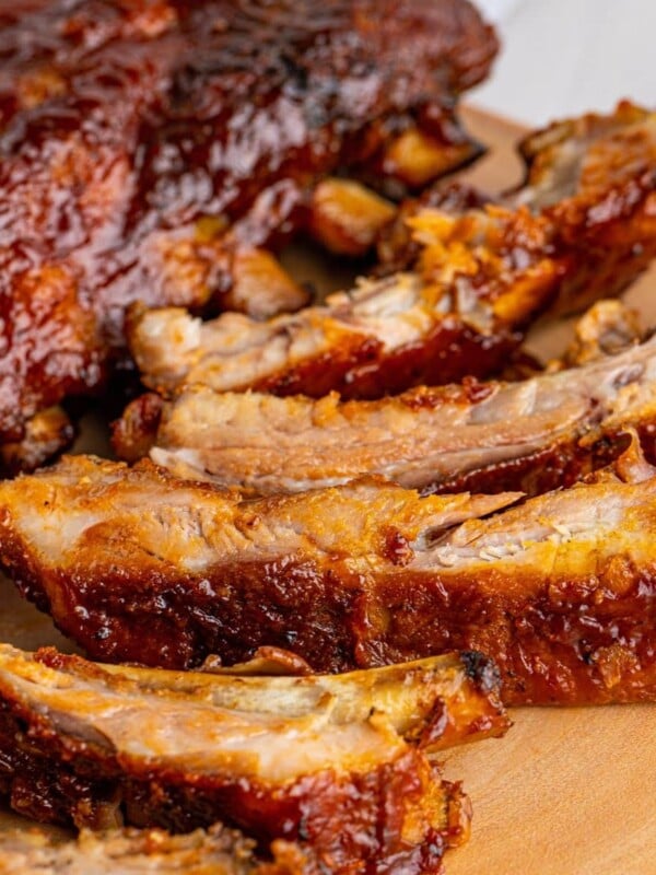picture of ribs slathered in sauce on a wood platter