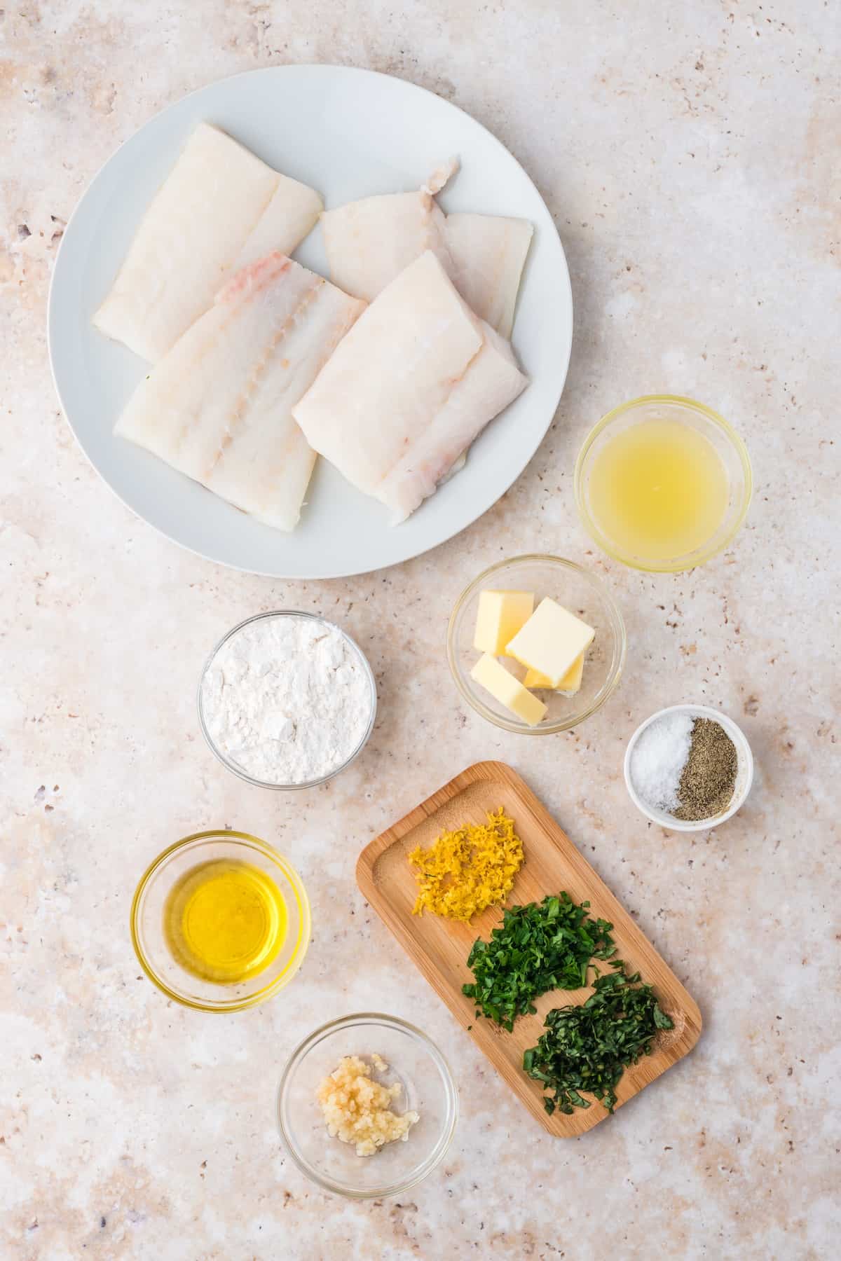 Pan Fried Cod fillet ingredients on a white plate.