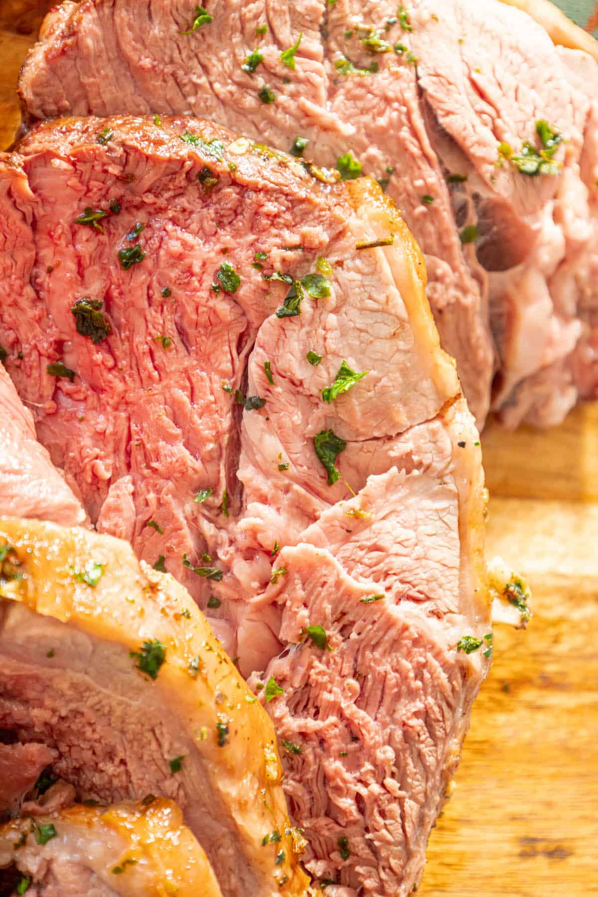 A reverse seared leg of lamb on a cutting board.