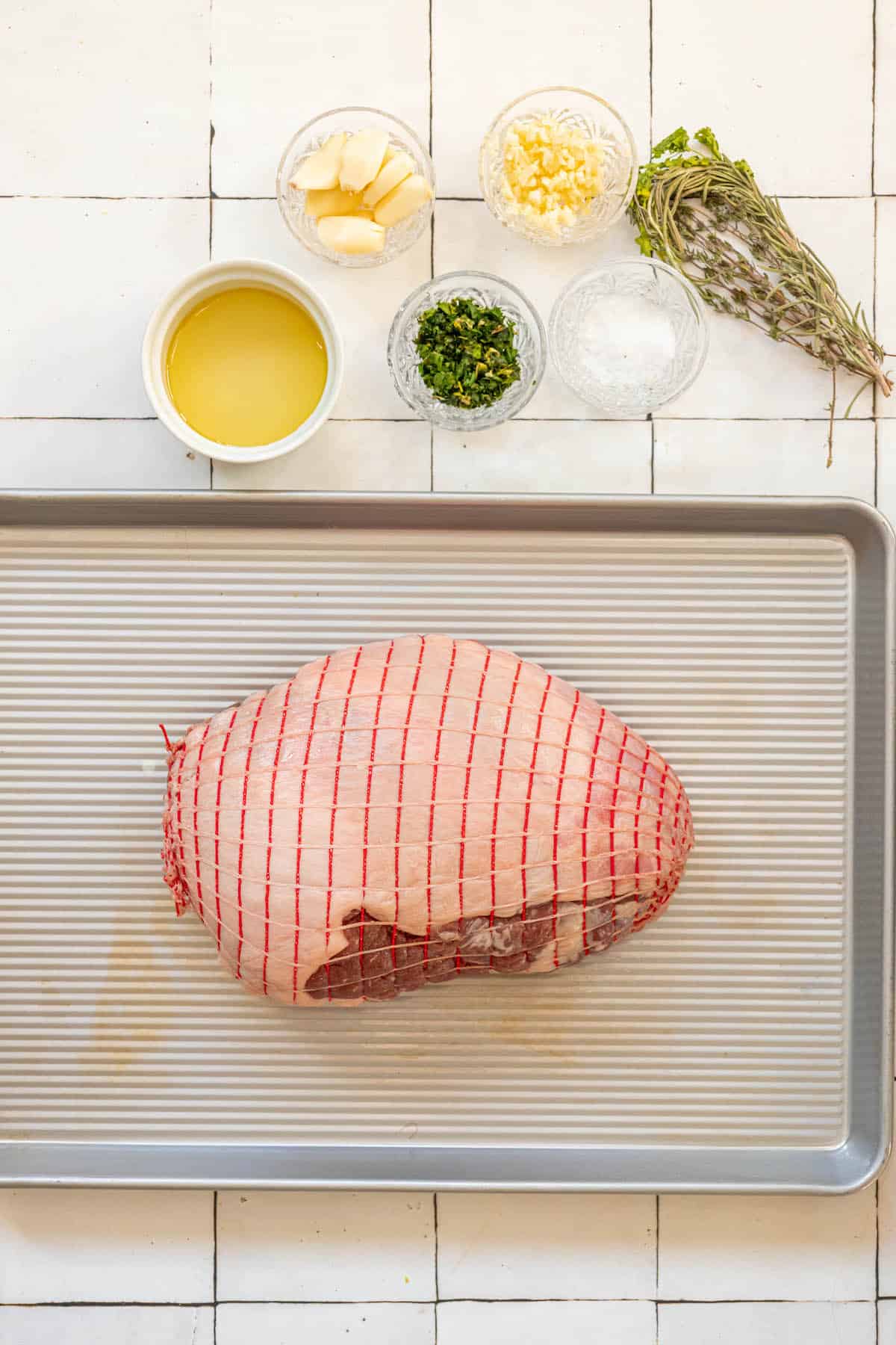 The recipe for reverse seared leg of lamb on a baking sheet.