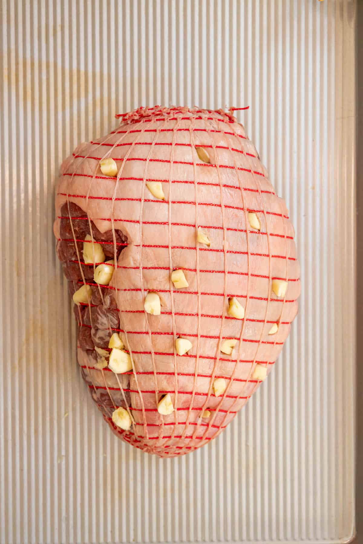 A reverse-seared leg of lamb on a baking sheet.