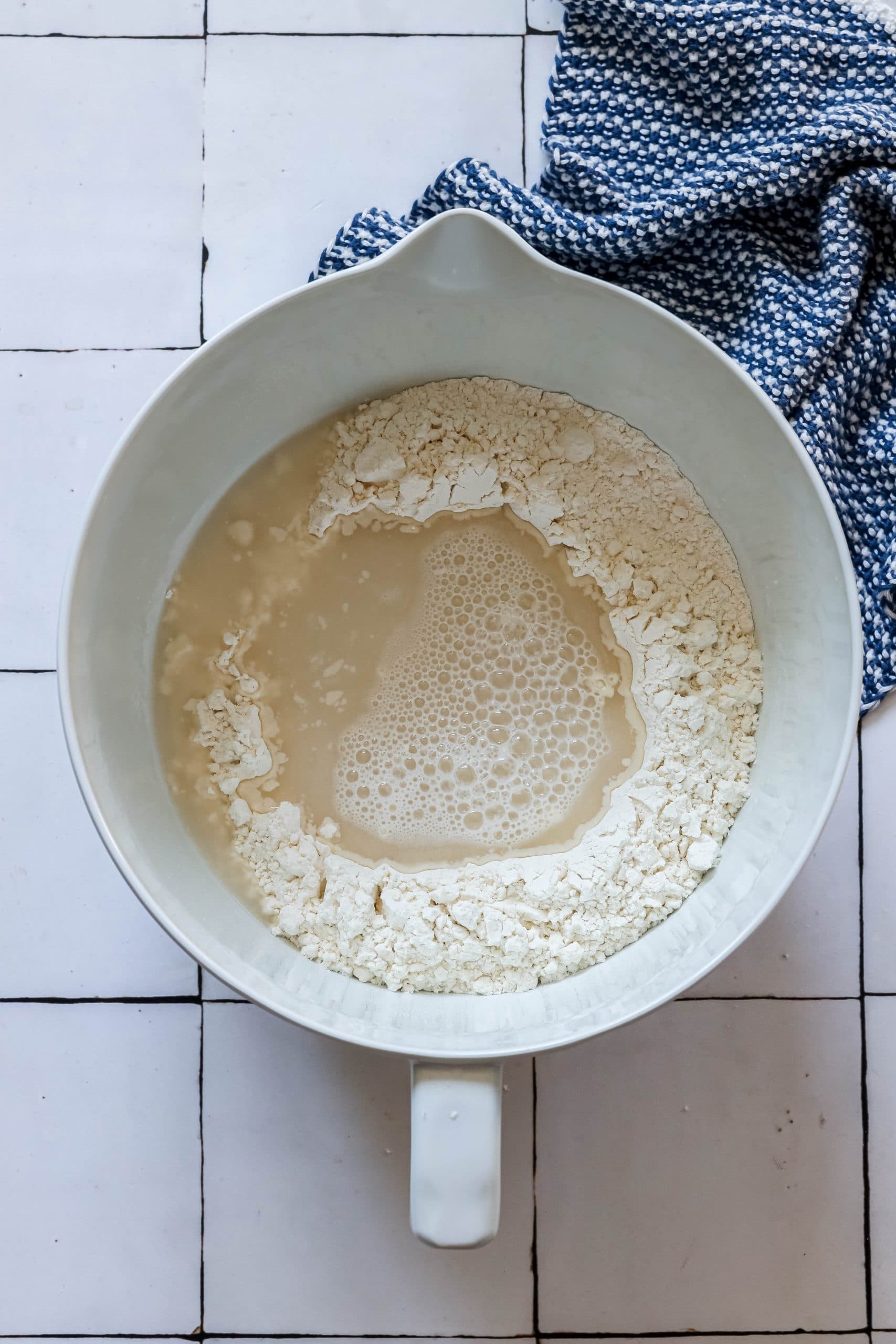 picture of water poured into the middle of well in flour in mixing bowl