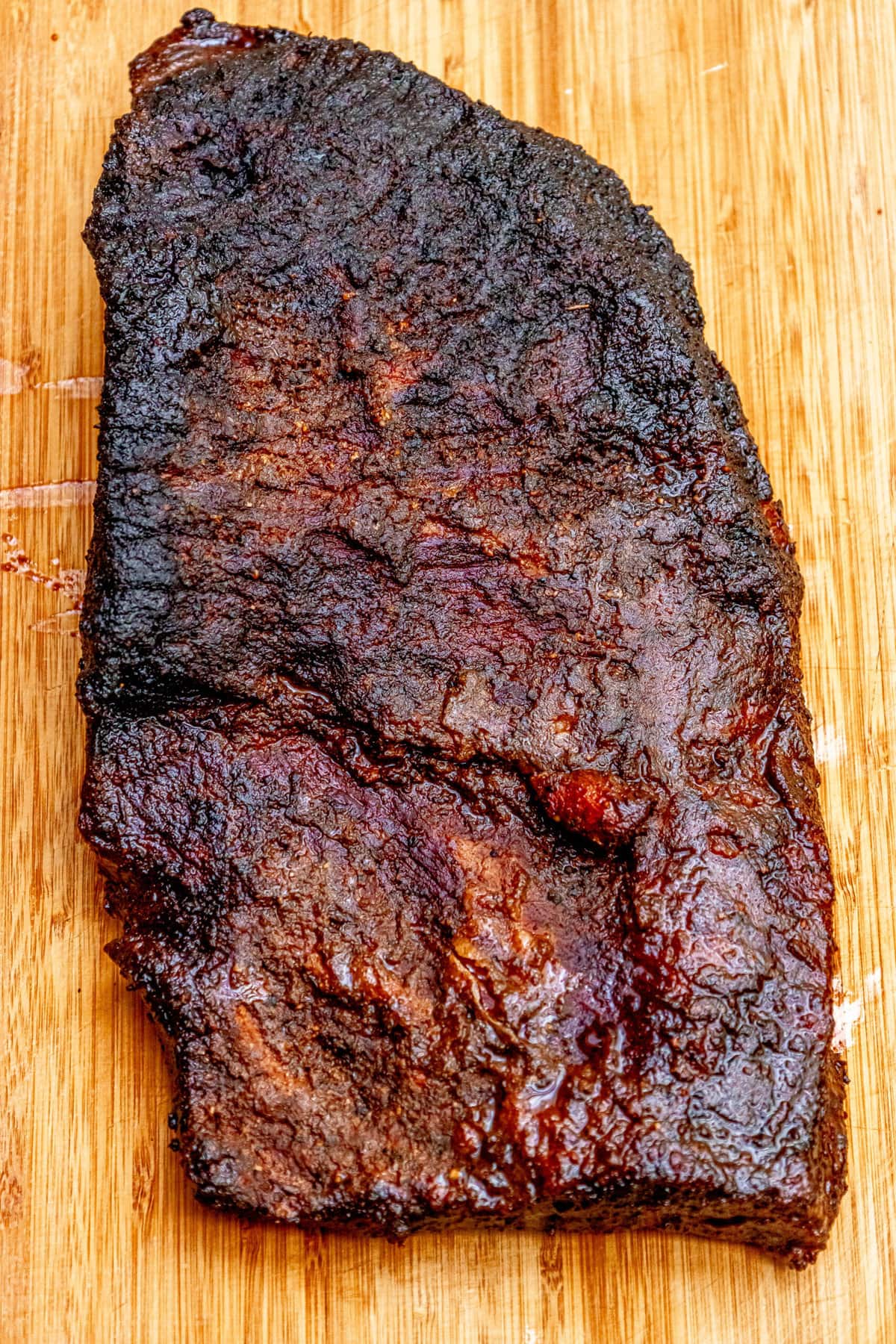 A mouthwatering piece of BBQ ribs on a cutting board.