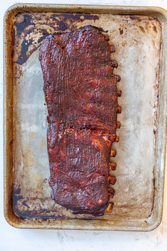 picture of sauced ribs on a baking sheet