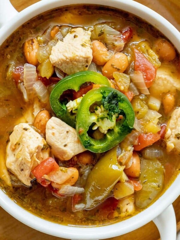 chicken stew with diced chicken breasts, tomatillos, onions, pinto beans, diced tomatoes, and sliced jalapeรฑos on top
