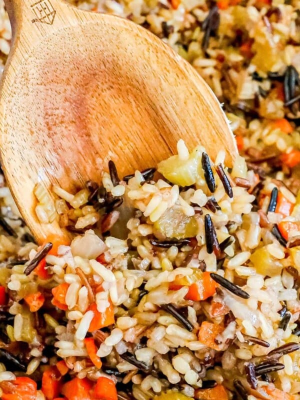 picture of wooden spoon in wild rice pilaf